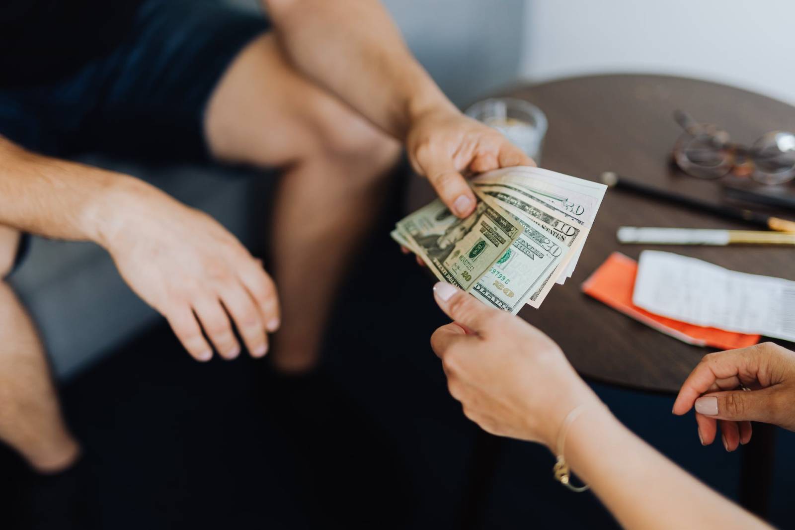 person giving money to another person