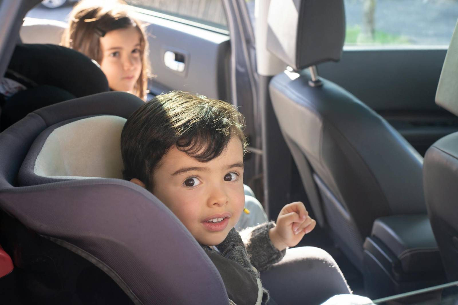 boy sitting on car seat