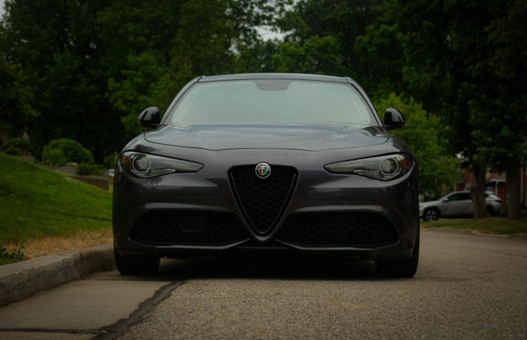 black alfa romeo giulia on street